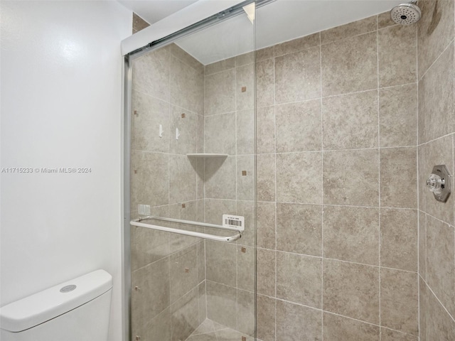 bathroom featuring an enclosed shower and toilet