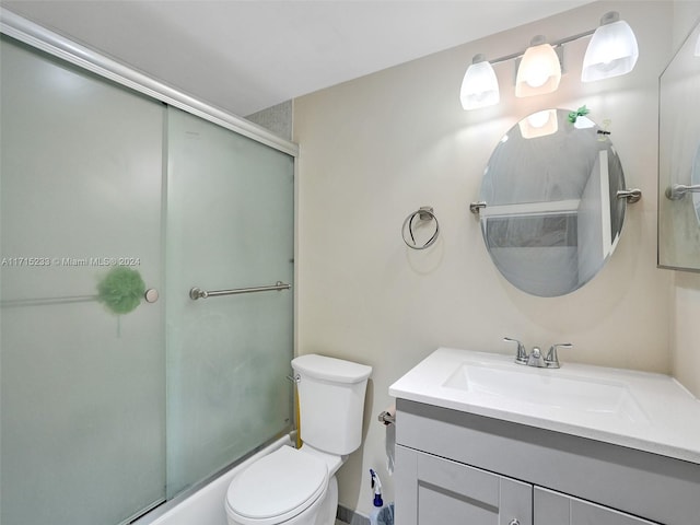 full bathroom with vanity, combined bath / shower with glass door, and toilet