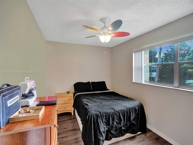 bedroom featuring a textured ceiling, dark hardwood / wood-style flooring, and ceiling fan