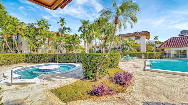 view of pool with a jacuzzi