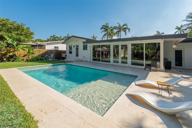 view of swimming pool featuring a fenced in pool, french doors, a patio area, and fence