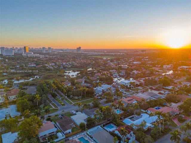 aerial view at dusk with a water view