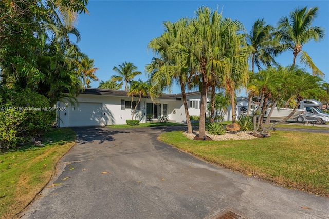 view of front of home featuring a garage and a front yard