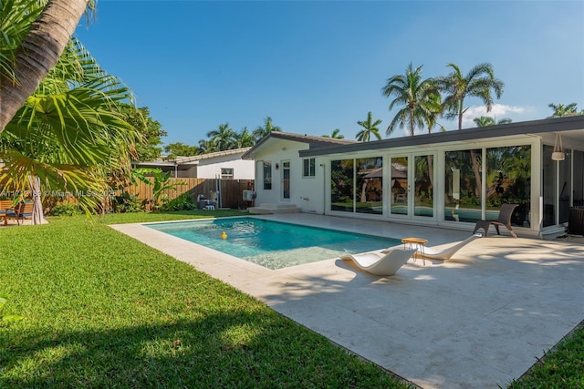 view of pool featuring a yard and a patio