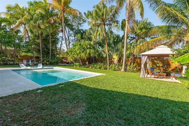 view of swimming pool with a gazebo, a diving board, a patio area, and a lawn