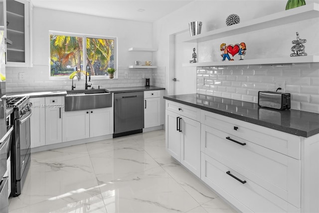 kitchen featuring white cabinets, backsplash, sink, and appliances with stainless steel finishes