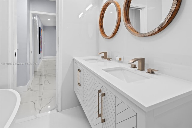 bathroom with vanity and a washtub