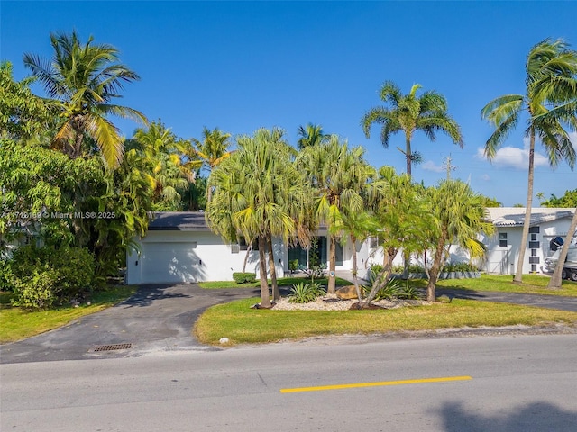 obstructed view of property with a garage