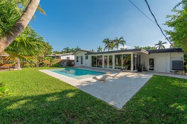 view of swimming pool with a lawn, a patio area, and a diving board