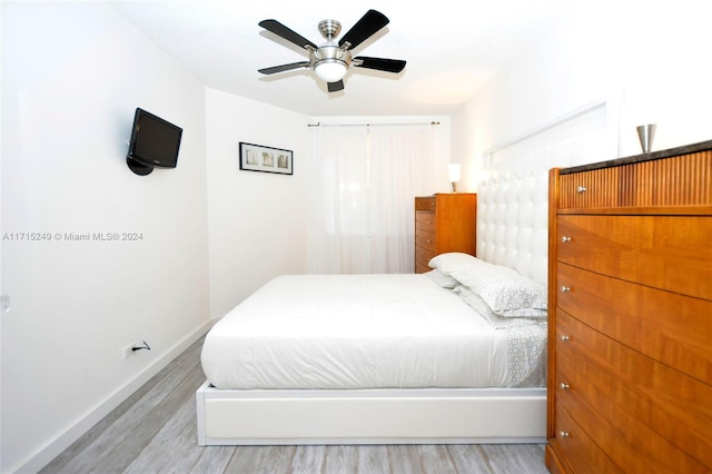 bedroom with light wood-type flooring and ceiling fan