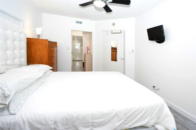 bedroom featuring connected bathroom, ceiling fan, and hardwood / wood-style floors