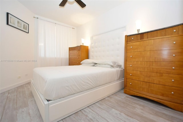 bedroom with ceiling fan and light wood-type flooring