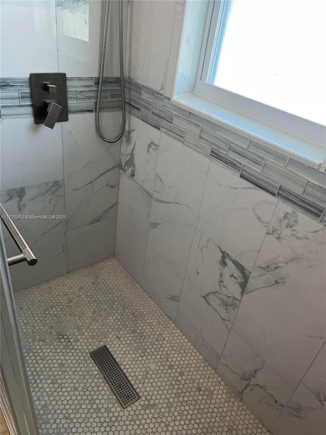 bathroom with tiled shower