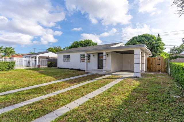 ranch-style house featuring a front yard and a carport