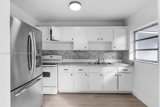 kitchen featuring white range with electric cooktop, white cabinets, sink, hardwood / wood-style flooring, and stainless steel refrigerator