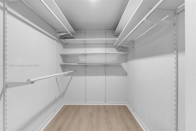 walk in closet featuring light hardwood / wood-style flooring