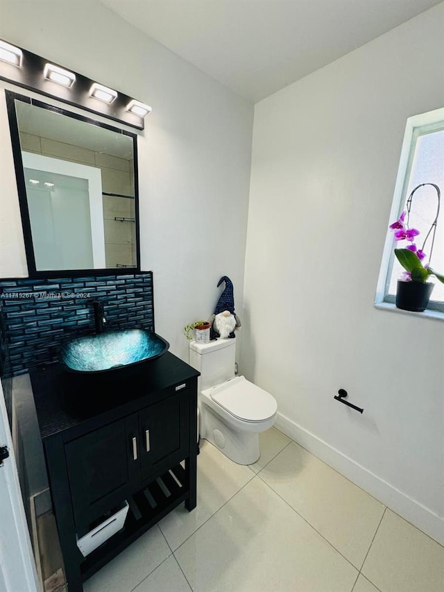 bathroom with tile patterned flooring, vanity, and toilet