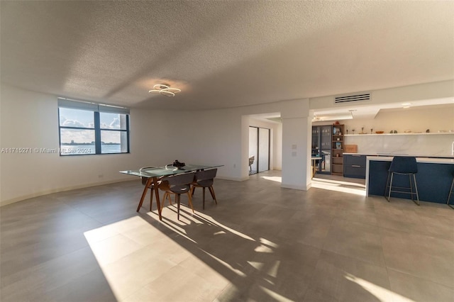 dining room featuring a textured ceiling