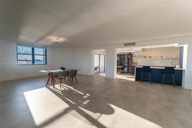 dining room featuring a textured ceiling and sink