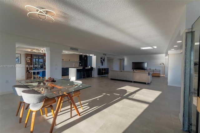 dining space with a textured ceiling