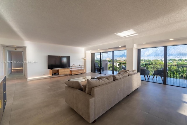 living room with a textured ceiling and concrete floors