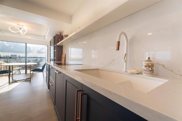 kitchen featuring black electric stovetop and sink