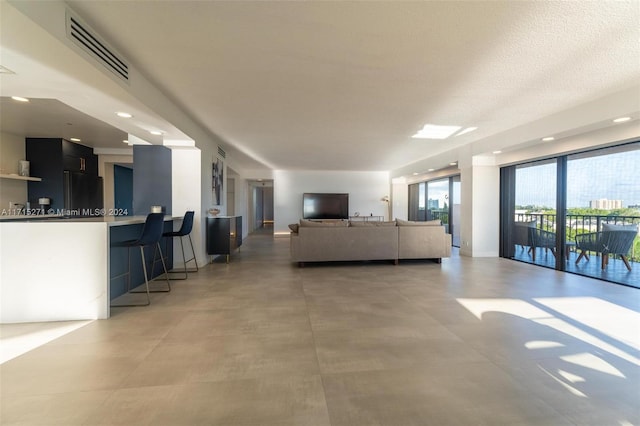 living room with concrete flooring and a textured ceiling