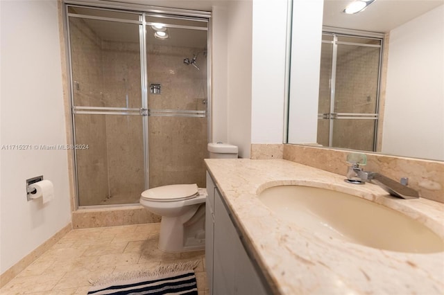 bathroom featuring vanity, an enclosed shower, and toilet