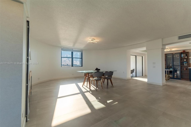 dining space featuring a textured ceiling