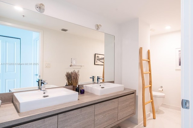 bathroom with tile patterned floors, vanity, and toilet