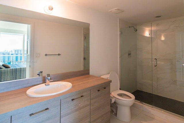 bathroom featuring vanity, toilet, and a shower with shower door