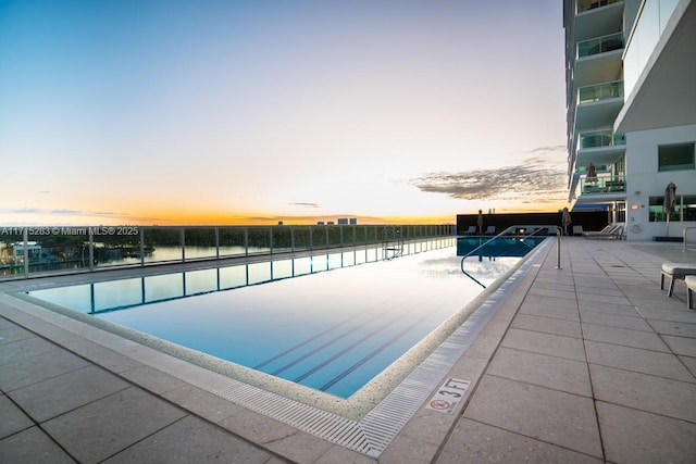 view of pool at dusk