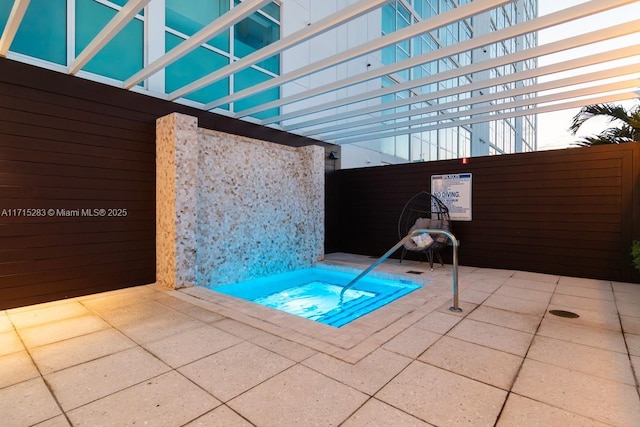 view of swimming pool featuring an in ground hot tub and a patio