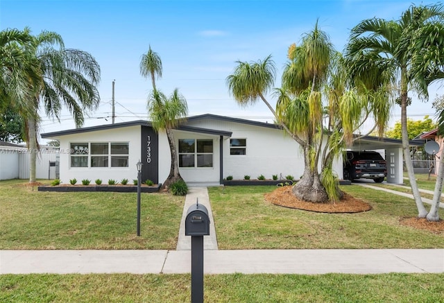 ranch-style house with a front yard and a carport