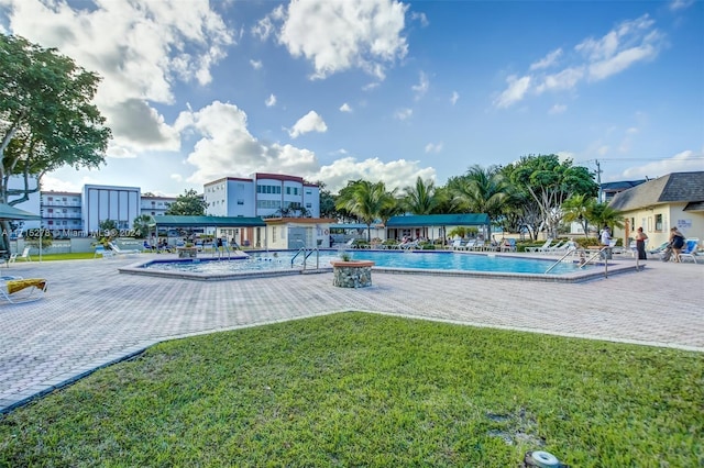 view of swimming pool with a yard and a patio