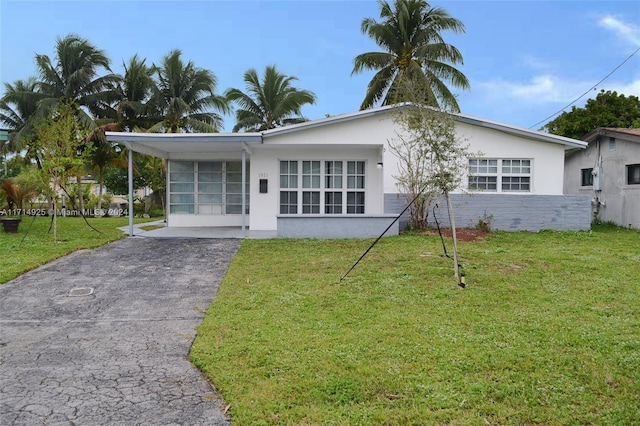 view of front facade with a carport and a front lawn