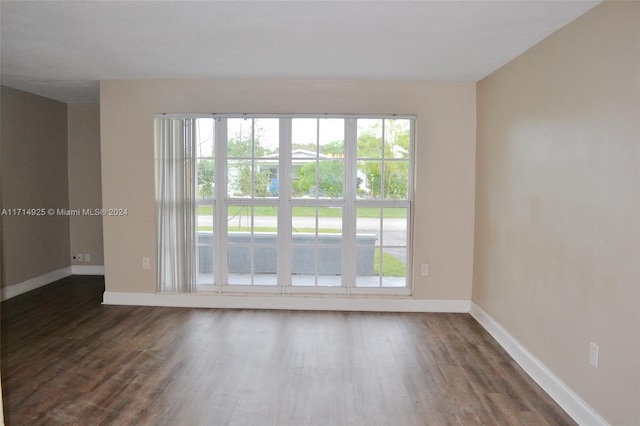 unfurnished room with dark hardwood / wood-style floors