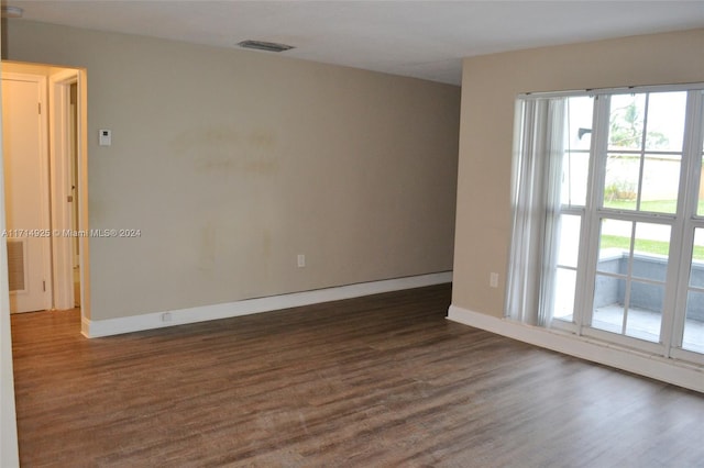 unfurnished room featuring dark hardwood / wood-style flooring