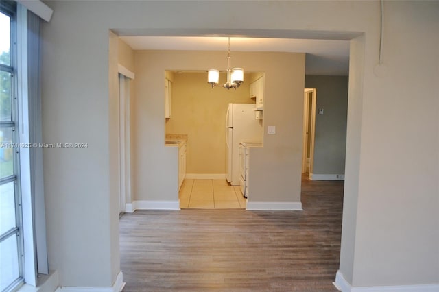 interior space with an inviting chandelier and light wood-type flooring