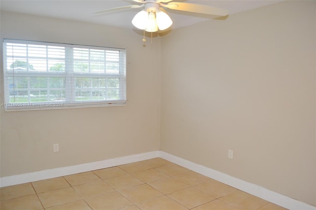 tiled spare room with ceiling fan