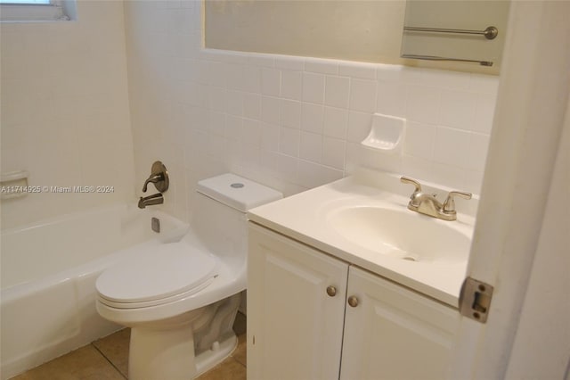 full bathroom with shower / washtub combination, tile walls, tile patterned flooring, vanity, and toilet