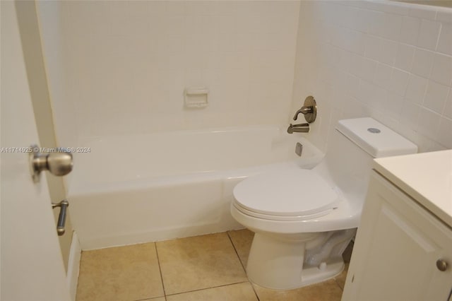 bathroom featuring tile patterned flooring, vanity, tile walls, and toilet