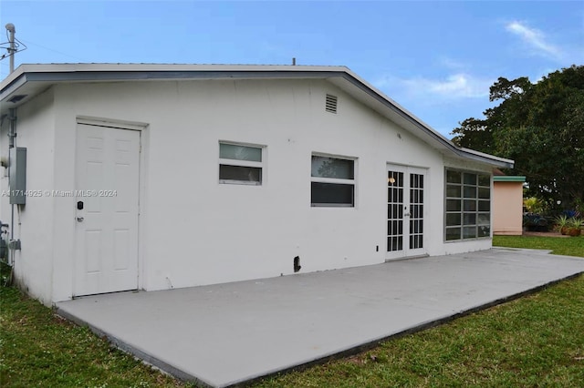 back of property featuring french doors and a patio area