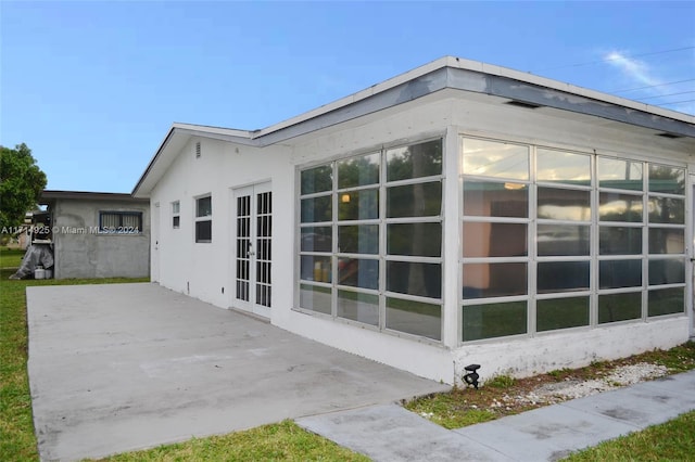 view of side of home with a patio area and french doors