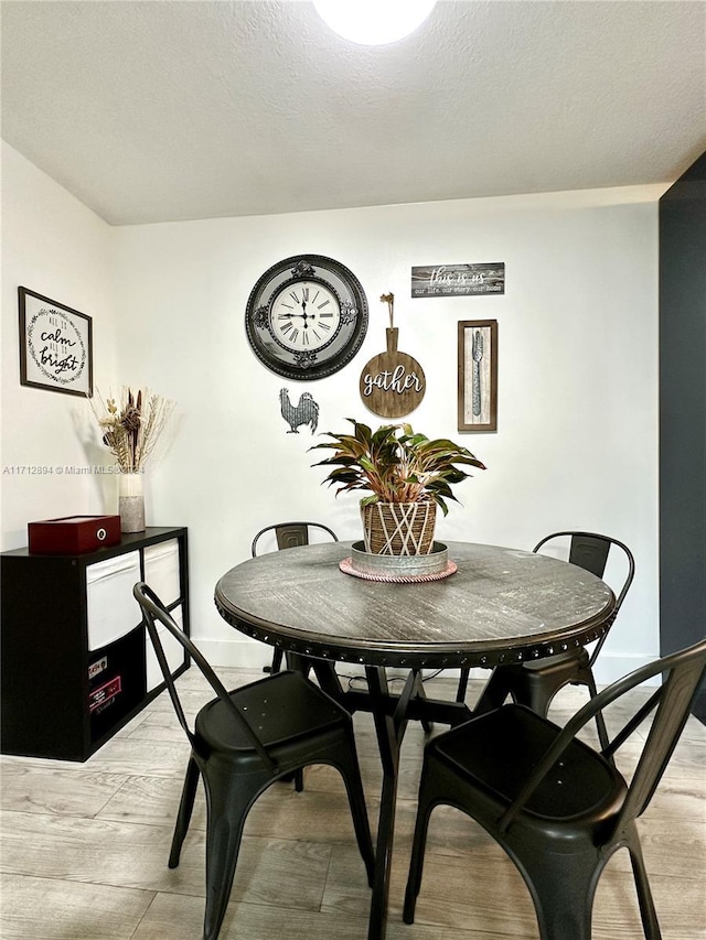 dining area featuring light wood-type flooring