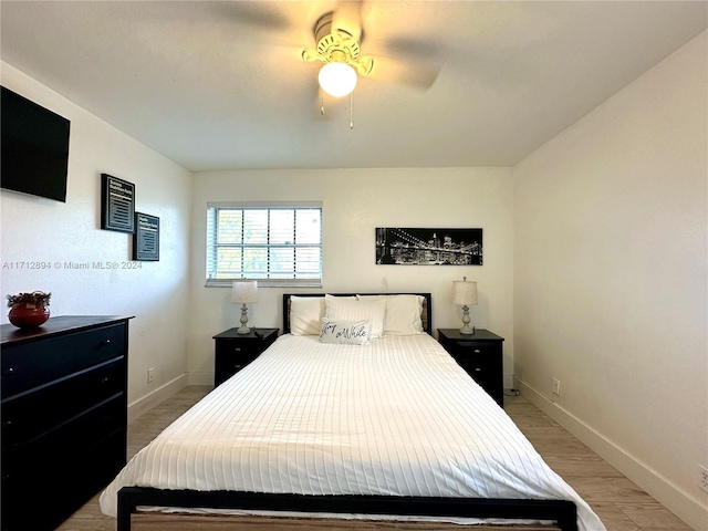 bedroom with light wood-type flooring and ceiling fan