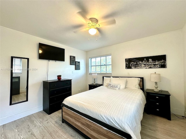 bedroom with ceiling fan and light hardwood / wood-style flooring