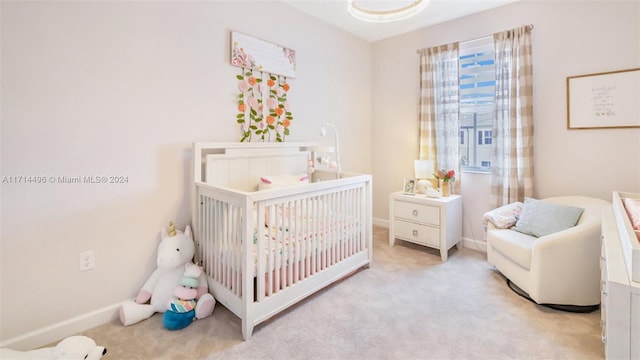 carpeted bedroom with a nursery area