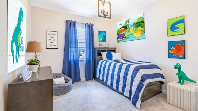 carpeted bedroom featuring a chandelier