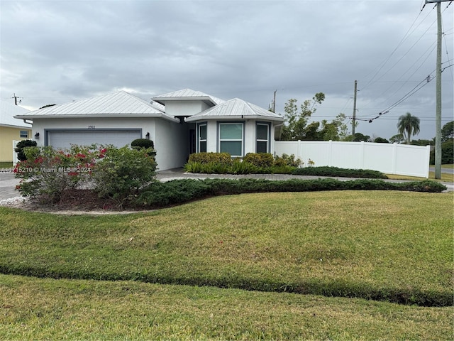 exterior space with a garage and a lawn